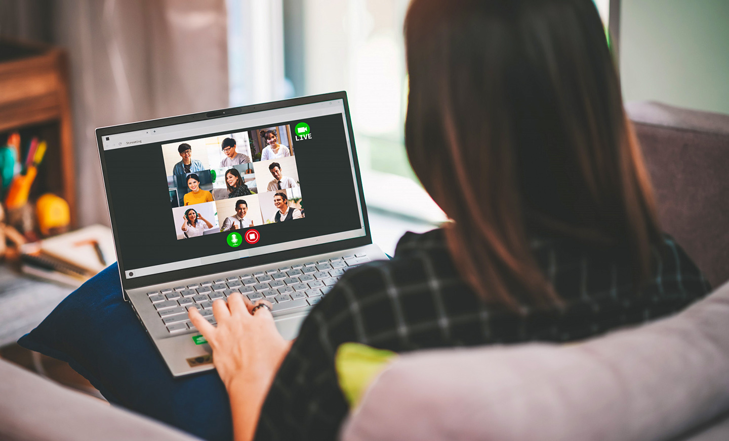 Business woman meeting with business people in a video conference at home